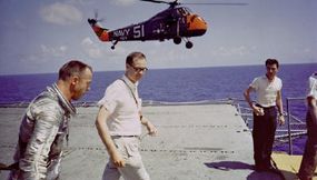 Alan Shepard during recovery (top) and on-board the carrier after his flight