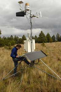 A scientist checks local conditions at a weather station in Arizona.