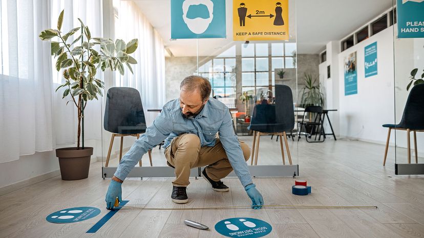 man measuring 2 meters apart