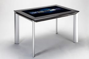 The Samsung SUR40 with Surface 2.0 shown here is only 4 inches (10.2 centimeters) deep. Its 1.0 ancestor, which housed cameras and projectors under the tabletop, sat on a full box unit full of component parts.
