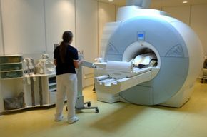A patient goes through an MRI machine.