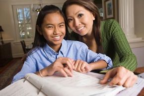 Mother helping preteen daughter with homework