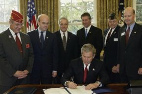 President George W. Bush signs the 2003 Military Family Tax Relief Act