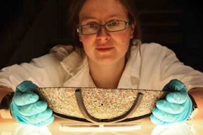 Museum of London Curator Liz Goodman holds a rare polychrome Roman millefiori dish found in an East London excavation. Goodman reassembled the dish, which is made of hundreds of indented glass petals.
