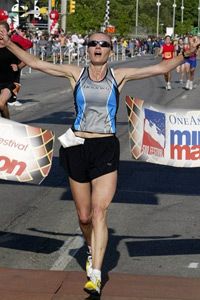 Lucie Mays-Sulewski of Westfield, Ind., crosses the finish line to win the women's division of the OneAmerica 500 Festival Mini-Marathon, Saturday, May 6, 2006 in Indianapolis.