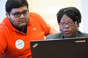 Counselor Diego Osorio helps Addie Whitaker shop for health insurance as the second round of open enrollment for the Affordable Care Act opens in late 2014.