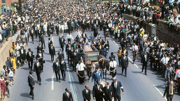 Crowd of city dwellers walking together from a high angle.