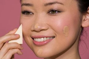 woman applying makeup with a sponge