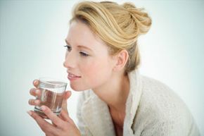 Young woman with glass of water.