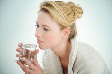 Young woman with glass of water.