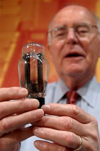 Gordon Moore holds a vacuum tube, the precursor to transistors.