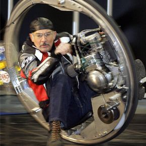 Kerry McLean drives his monowheel during a press preview for the Essen Motor Show fair in Essen, Germany.