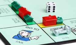 This game is breaking two of the building rules: Properties within a set are being developed unequally, and building beyond a single hotel per property is allowed.