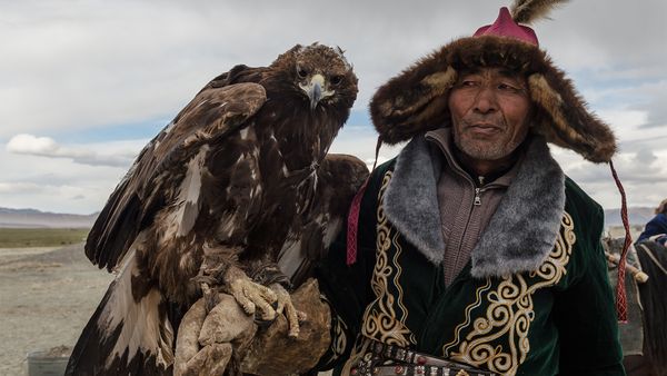 Men outdoors in nature, animal portrait.