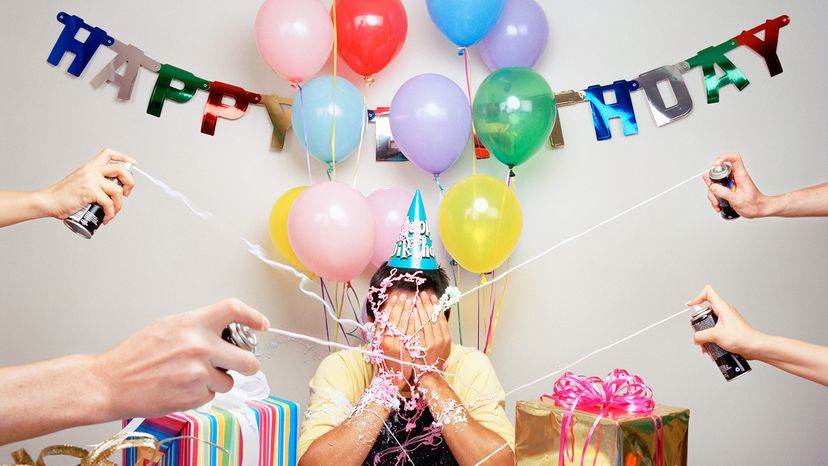 man getting covered in silly string on birthday