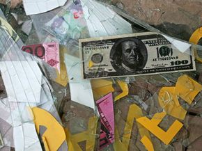 A U.S. 100 dollar bill sticker lies among broken glass from an exchange shop damaged in a car bombing Baghdad, Iraq. The blast killed five people and injured about 20. See more men of war pictures.