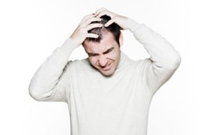 Frustrated man scratching head