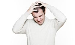 Frustrated man scratching head