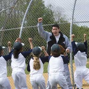 Coach cheering with his little league team.