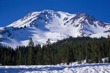 Snowy winter atop mountain peak outdoors.