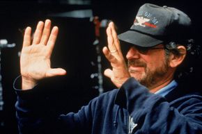 American director Steven Spielberg frames a shot on the set while directing his film 'Jurassic Park: The Lost World,' 1997. See more movie making pictures.