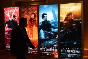 A person walks past "Star Trek Into Darkness" movie posters. 