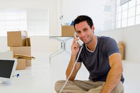 Man using telephone in empty home