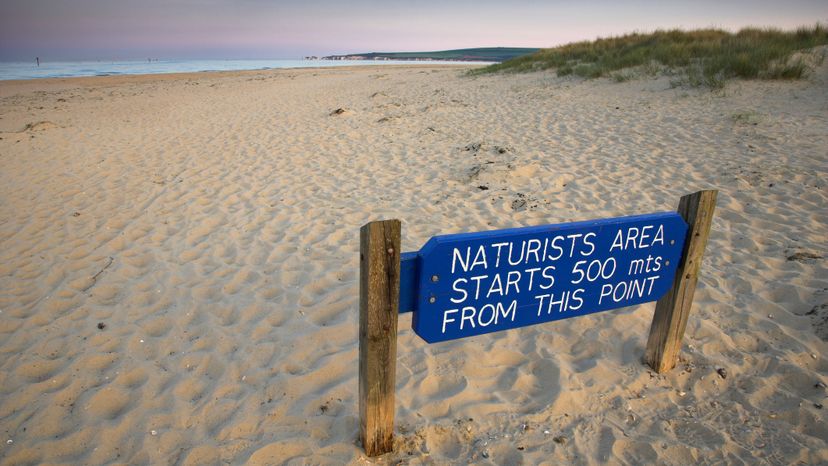 A sign alerts beachgoers in Dorset, England, that a nude beach lies ahead. Oxford Scientific/Getty Images