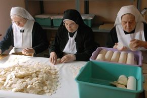 Polish nuns prepare communion hosts for a service.