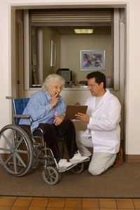 woman in wheelchair with nursing home orderly