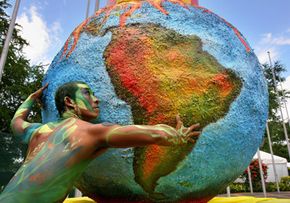 The origins of &quot;America&quot; are bit obscure. A dancer performs next to a globe during the UN Climate Change Conference in 2007.