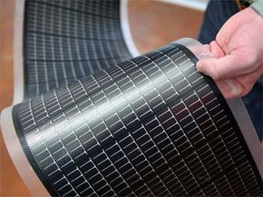 An engineer holds a sheet of thin-film solar cells at the National Renewable Energy Laboratory in Golden, Colo. Thanks to relatively low pricing and adaptability, thin film solar panels have quickly come to dominate the U.S. market in the last two years.
