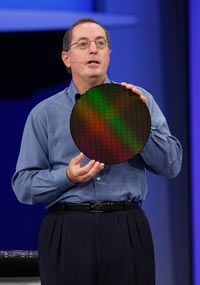 Intel CEO Paul Ortelli holds a wafer of computer chips with 32-nanometer circuitry.