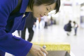 Woman drinking from water fountain