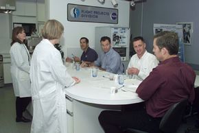 STS-113 crewmembers are briefed by dietitians during a food tasting.