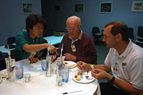 Astronauts sample space foods.