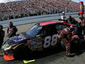 The pit stop crew performs various tune-ups, not the least of which is wedge adjustment. In the above picture, the crew member reaching over the rear windshield is adjusting the wedge.