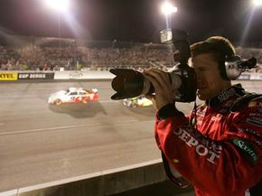 Carl Edwards, driver of the #99 Office Depot Ford, shoots a camera during the NASCAR Nextel Cup Series Chevy Rock &amp; Roll 400 at Richmond International Raceway on Sept. 8, 2007 in Richmond, Va.