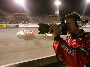 Carl Edwards, driver of the #99 Office Depot Ford, shoots a camera during the NASCAR Nextel Cup Series Chevy Rock & Roll 400 at Richmond International Raceway on Sept. 8, 2007 in Richmond, Va.