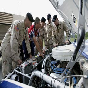 Roush Racing crew chief Doug Richert explains engine design and performance to members of the North Carolina National Guard. 