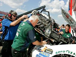 Dale Earnhardt Jr.'s pit crew install a new engine in his car during practice for the Amp Energy 500 on Oct. 3, 2008. NASCAR engines cost between $45,000 and $80,000.