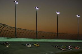 Cars race around the track in the NASCAR Nextel Cup Series Ford 400 at Homestead-Miami Speedway in Homestead, Fla., on Nov. 18, 2007.