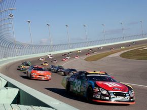 NASCAR race cars exiting a turn