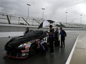 NASCAR crew members wait out race rain delay.