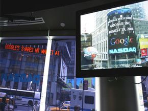 ­Investing Image Gallery The Google logo appears on a screen and ticker inside the NASDAQ MarketSite just before the markets closed on Aug. 19, 2004. Shares of Google closed at 100.34, $15.34 higher than it opened. See more ­investing pictures.