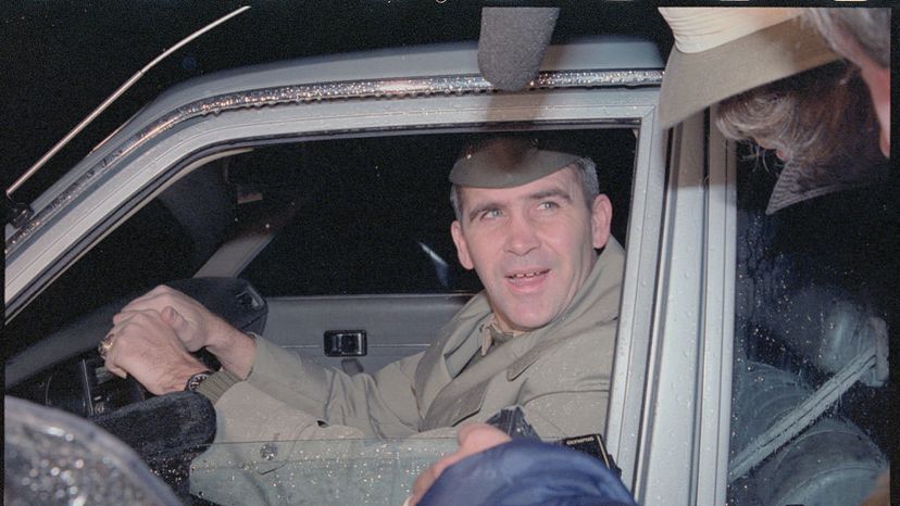 Marine Lt. Col. Oliver North leaves his home early on Dec. 18, 1986,  in suburban McLean, Virginia. North, the fired National Security Council member, was under fire for his reported role in the Iran arms-Contra aid controversy.  Bettmann/Getty Images