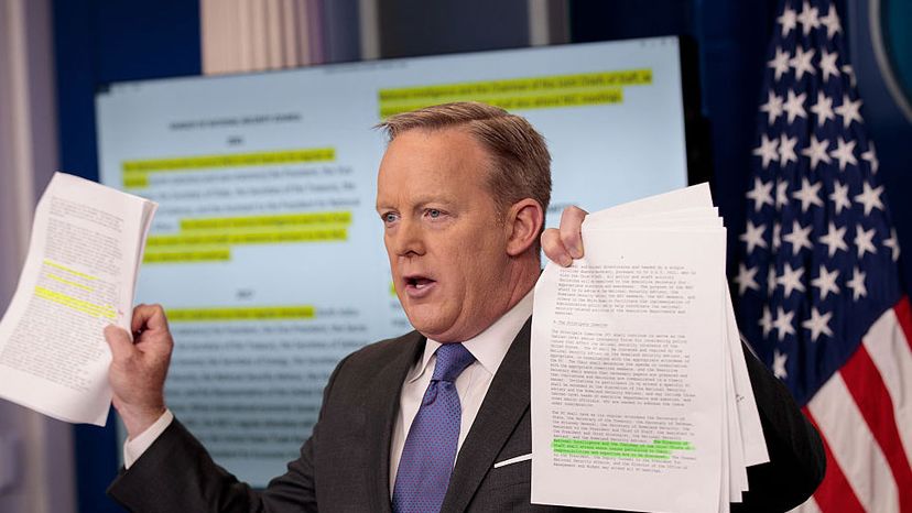 White House Press Secretary Sean Spicer holds up paperwork highlighting and comparing language about the NSC from the Trump administration and previous administrations during the daily press briefing, Jan. 30, 2017, in Washington, D.C. Drew Angerer/Getty Images