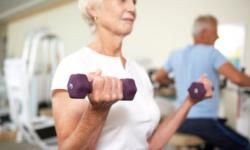 Elderly woman lifting weights