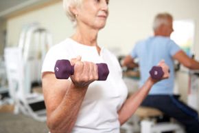 Elderly woman lifting weights