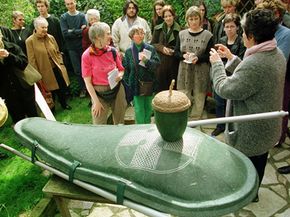 An Ecopod and an acorn urn are displayed at a natural burial event. Both reflect the growing demand for environmentally sound funerals.